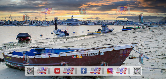 Red canoe in the forground Balboa Island Newport beach overlooking the fun zone